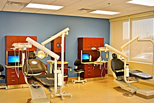 Two examination chairs in this dental school are clearly visible thanks to new commercial lighting from Rains Electric Company.