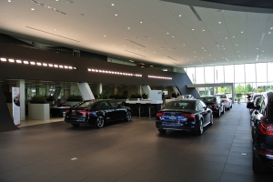 This Audi showroom utilizes natural, and interior lighting, to highlight the best qualities of featured models for sale.