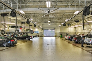 The commercial lighting upgrade at this car dealership's service area helps mechanics work productively and safely.